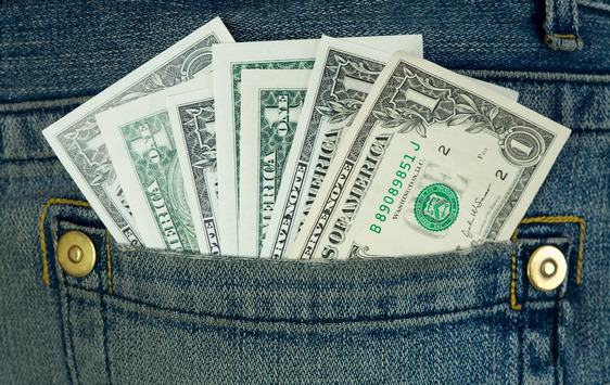 Dollars jut out on hip-pocket jeans close up